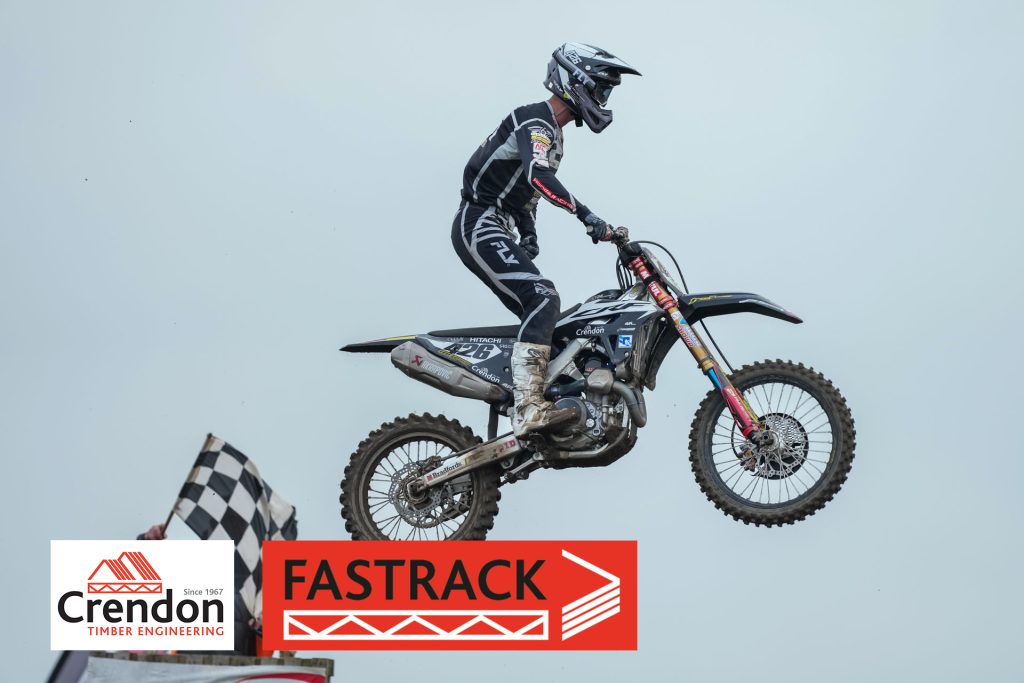 Motorcross rider on bike jumping through air