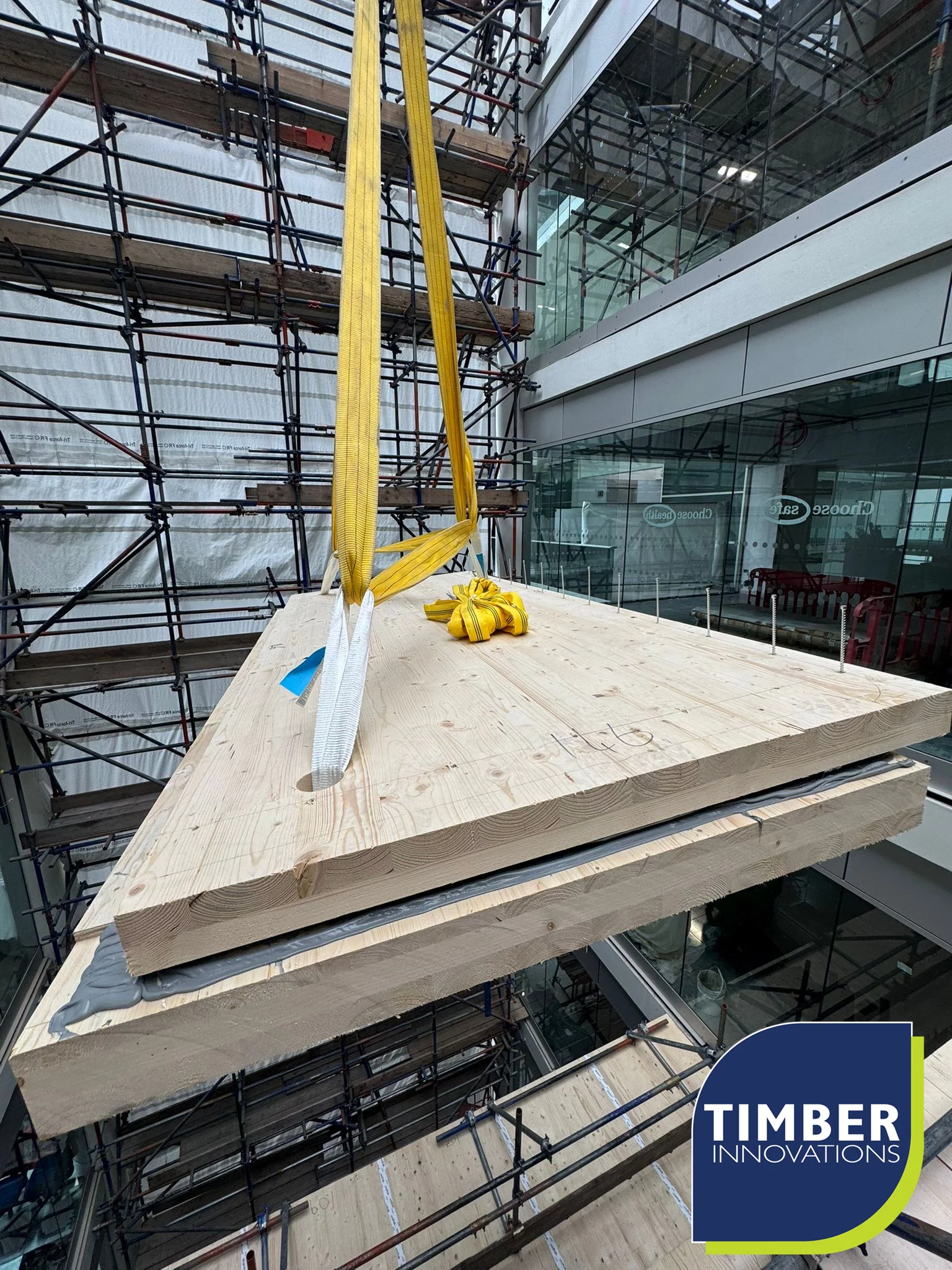 Crane lifting wooden panels