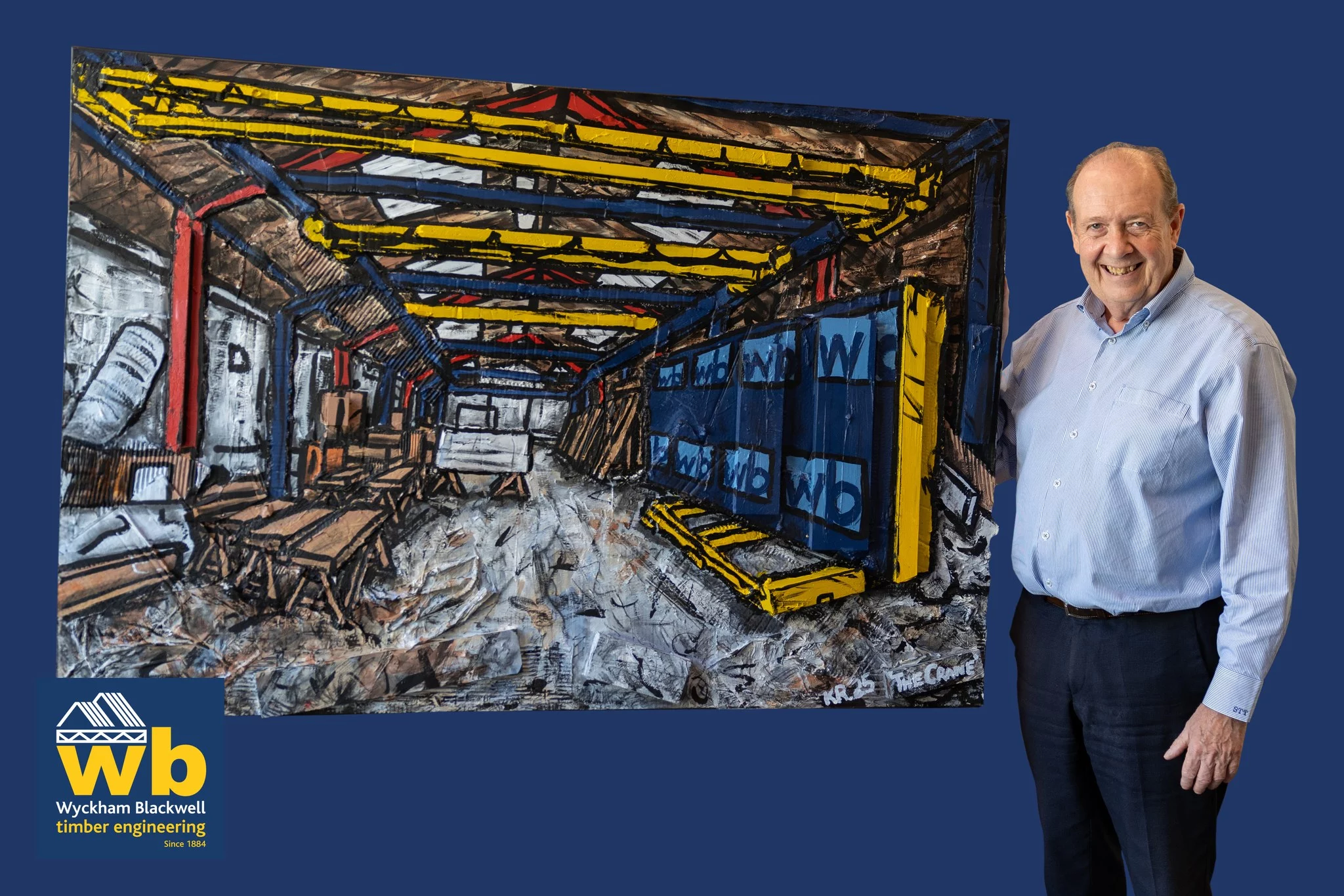 Man in shirt holding up artwork