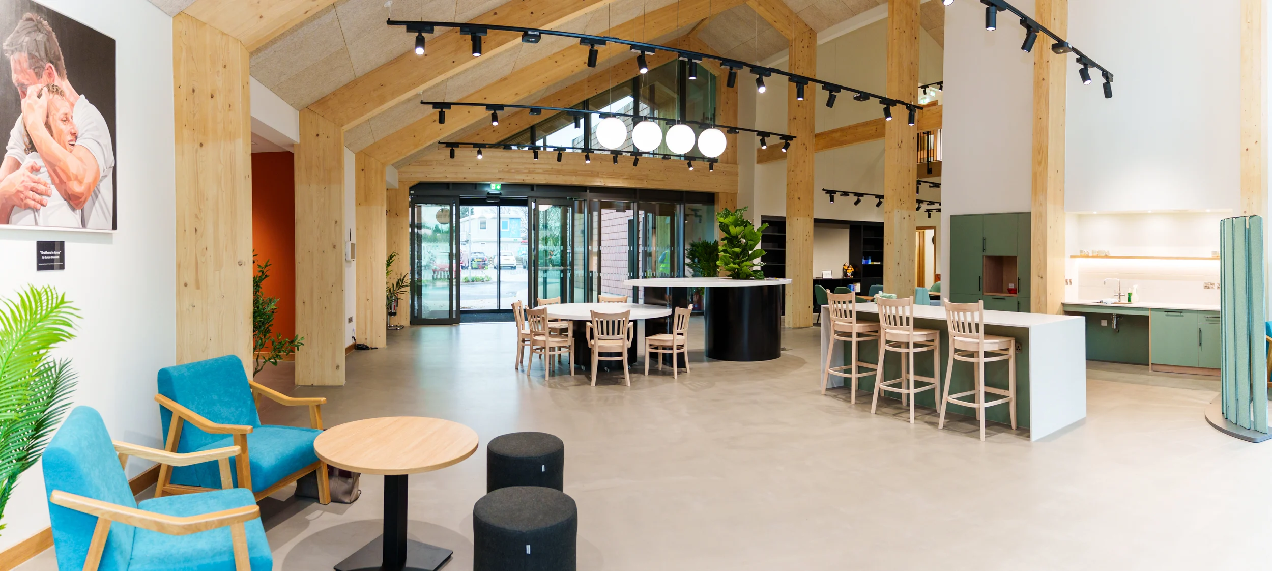 A timber arched structured room with a selection of modern furniture.