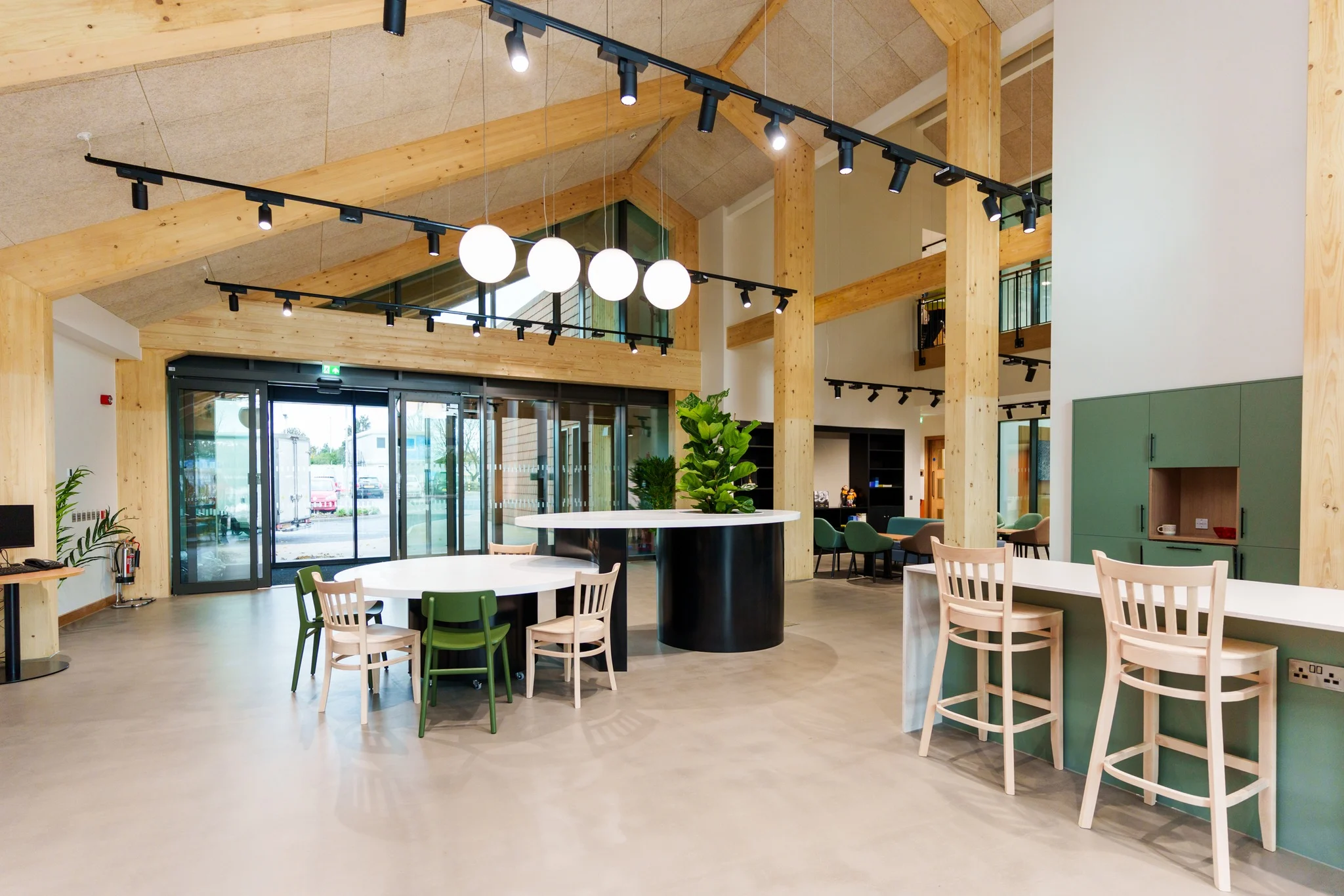 A timber arched structured room with a selection of modern furniture.